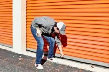 The man drops to his knees when he sees a safe inside a storage container